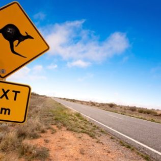 Australia outback road with kangaroo sign